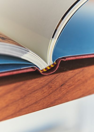 An open book on the cherry wood shelving. Photo Armin Tehrani