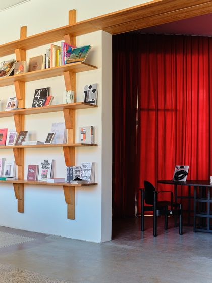 The Red Room through the shelving. Photo Armin Tehrani