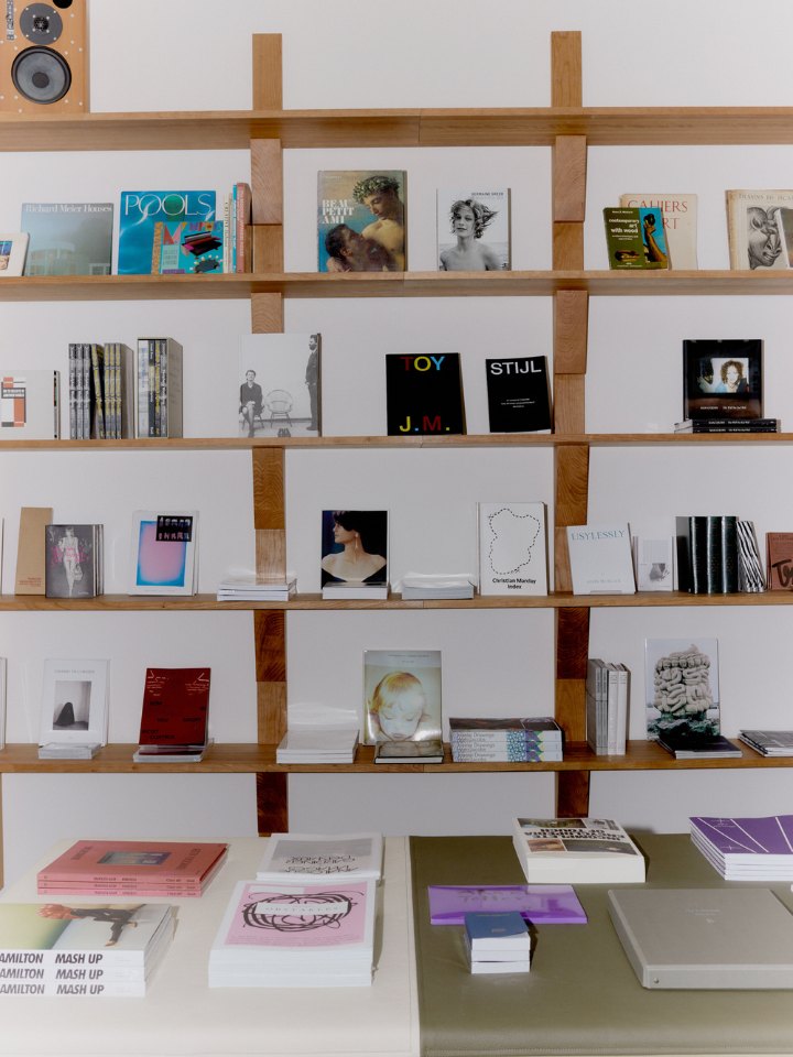 Books face out on the cherry-wood shelves above the counter at Simone